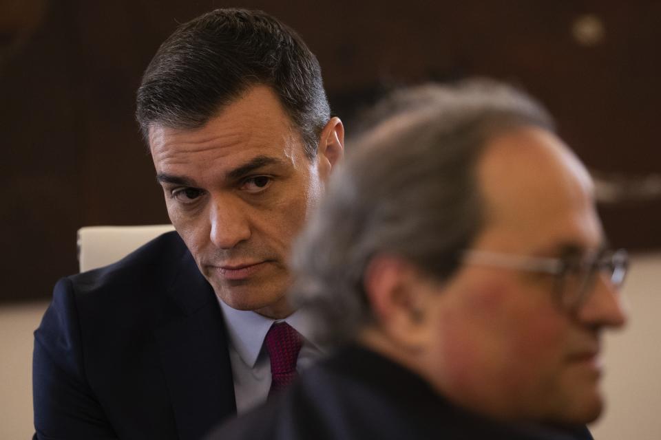 Spanish Prime Minister Pedro Sanchez, left, sits next Catalan regional President Quim Torra at the Moncloa palace in Madrid, Spain, Wednesday, Feb. 26, 2020. Spain's prime minister and the leader of Catalonia are opening formal talks Wednesday in hopes of resolving the festering political crisis provoked by the region's separatist movement. (AP Photo/Bernat Armangue)