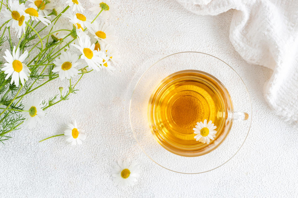 A close-up of chamomile tea with chamomile flowers