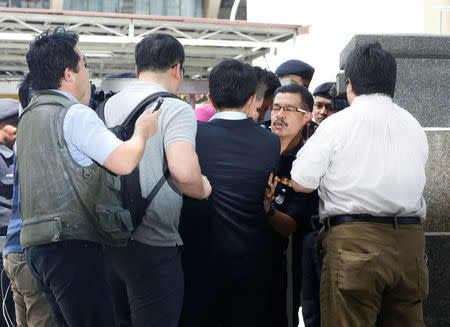 Media journalists scuffle with a police officer as they try to interview a North Korea official at the morgue at Kuala Lumpur General Hospital where Kim Jong Nam's body is held for autopsy in Malaysia February 15, 2017. REUTERS/Edgar Su