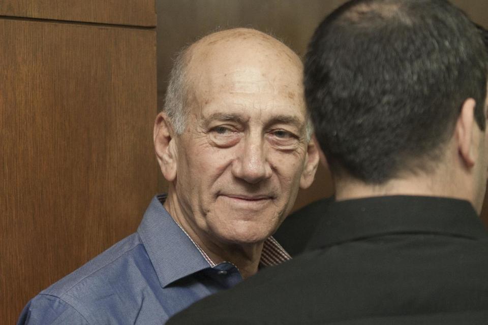 Former Israeli Prime Minister Ehud Olmert attends a hearing at Tel Aviv's District Court, Monday, March 31, 2014. The court handed down the verdict in the wide-ranging Jerusalem real estate scandal case related to Olmert’s activities before becoming prime minister in 2006. A total of 13 government officials, developers and other businesspeople were charged in three separate schemes. (AP Photo/Dan Balilty, Pool)