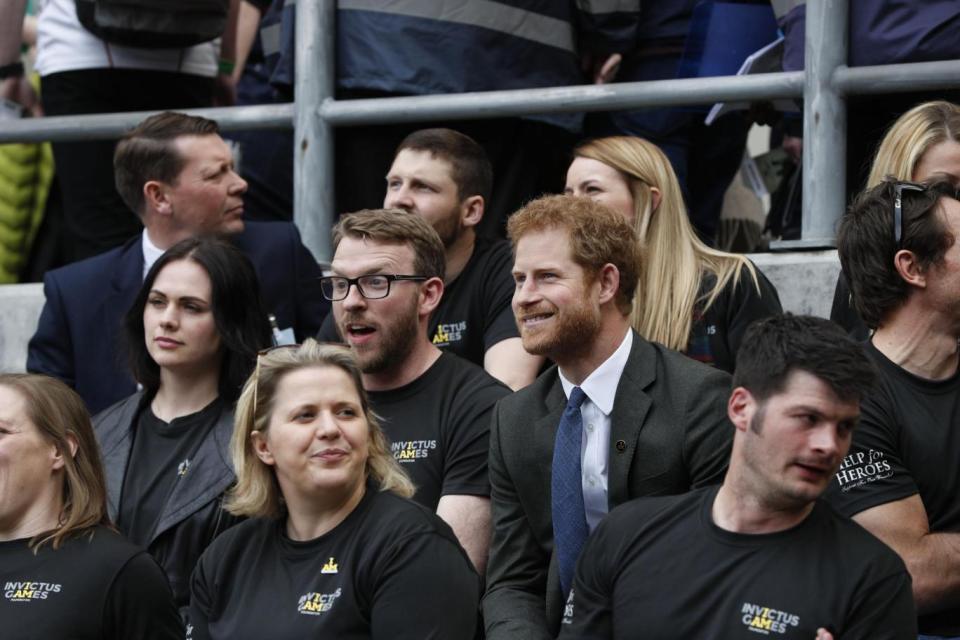 Prince Harry sits with competitors from the 2014 and 2016 Invictus Games (PA)