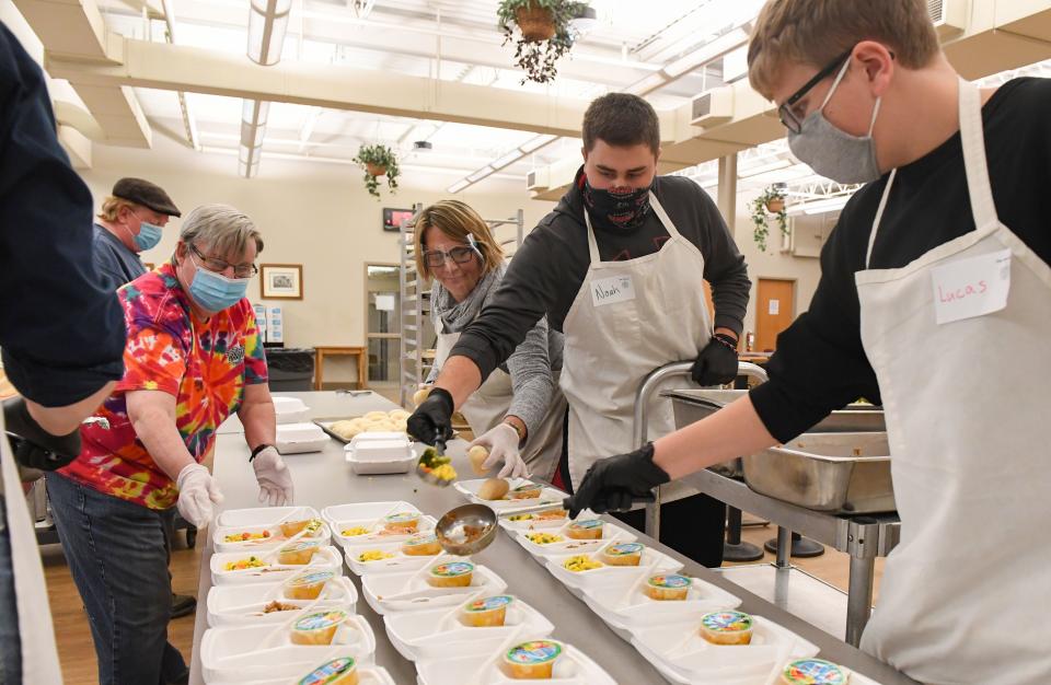 Volunteers package to-go meals on Wednesday, November 18, at The Banquet in Sioux Falls.
