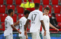 Benjamin Pavard of Munich, right, celebrates his side's second goal during the German Bundesliga soccer match between Union Berlin and Bayern Munich in Berlin, Germany, Sunday, May 17, 2020. The German Bundesliga becomes the world's first major soccer league to resume after a two-month suspension because of the coronavirus pandemic. (AP Photo/Hannibal Hanschke, Pool)