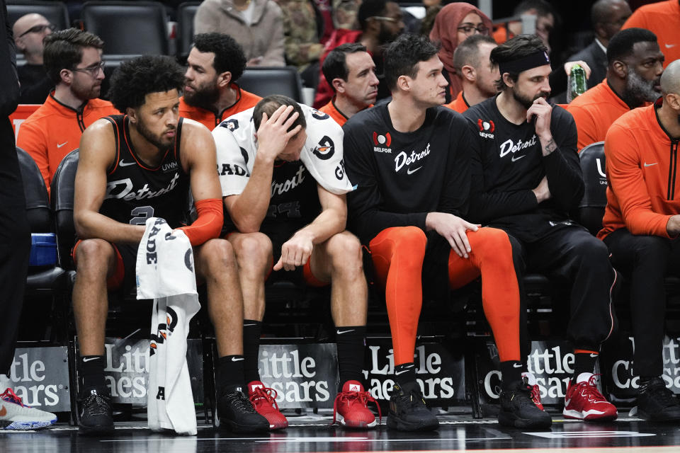 Detroit Pistons' Cade Cunningham, from left, Bojan Bogdanovic, Danilo Gallinari and Detroit Pistons forward Joe Harris watch from the bench against the Washington Wizards in the second half of an NBA basketball game in Detroit, Saturday, Jan. 27, 2024. (AP Photo/Paul Sancya)