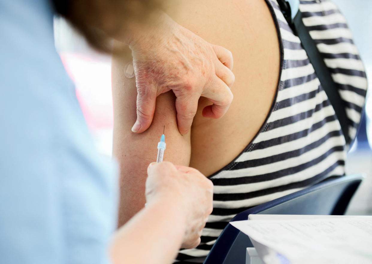 A healthcare worker administers a monkeypox vaccination at a clinic run by CIUSSS public health authorities in Montreal, Quebec, Canada, June 6, 2022.  REUTERS/Christinne Muschi