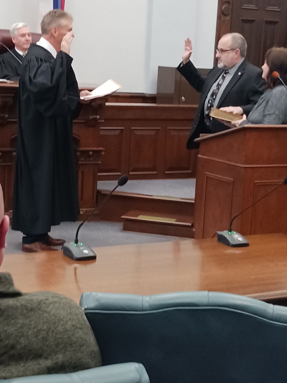 Guernsey County Commissioner Dave Wilson (right) is sworn in by Common Pleas Court Judge Daniel Padden. Wilson will serve a new four-year term.