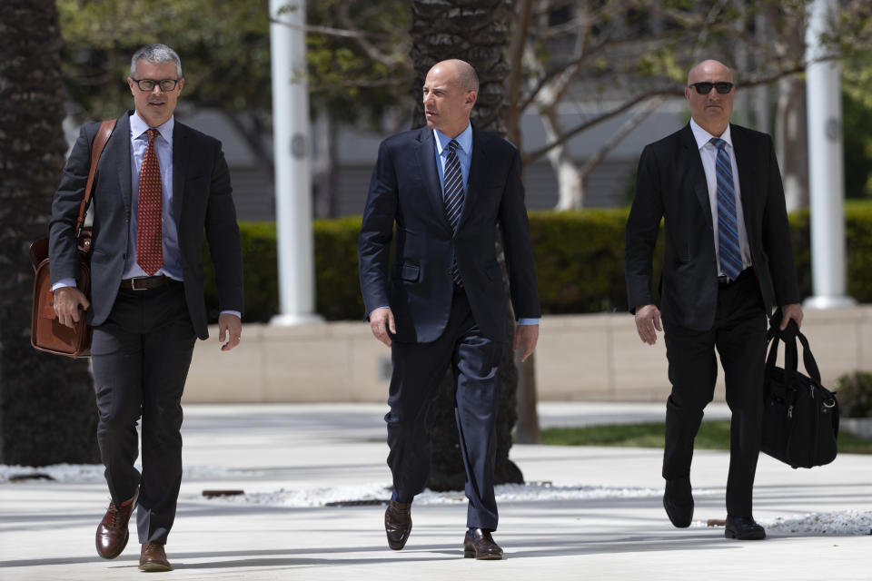 Attorney Michael Avenatti, center, arrives at federal court Monday, April 1, 2019, in Santa Ana, Calif. Avenatti appeared in federal court on charges he fraudulently obtained $4 million in bank loans and pocketed $1.6 million that belonged to a client. (AP Photo/Jae C. Hong)