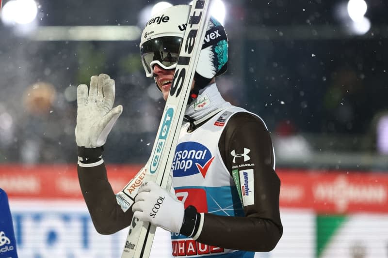 Slovenian ski jumper Lovro Kos reacts in the finish area of the men's first round of the Four-Hills tournament as part of the FIS Ski Jumping World Cup. Daniel Karmann/dpa