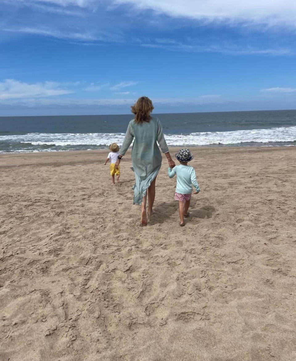 Alejandra Gere walks with her two sons on the beach. (@alejandragere on Instagram)