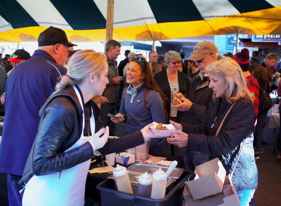 Guests enjoying food from Diego's at the Bowens Wharf Seafood Festival on 2019.