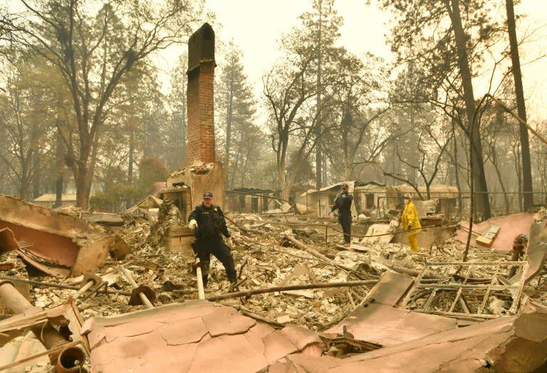 Officers search for human remains at a burned residence in Paradise, California