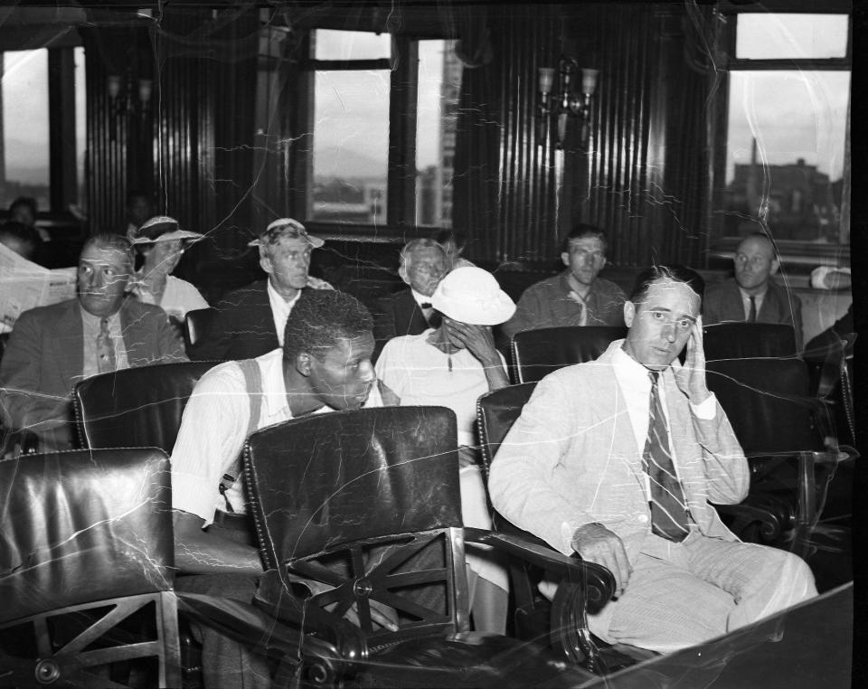 Martin Moore and his sister sit at the defense table with one of Martin's court appointed lawyers in the Buncombe County Courthouse, August 1936.