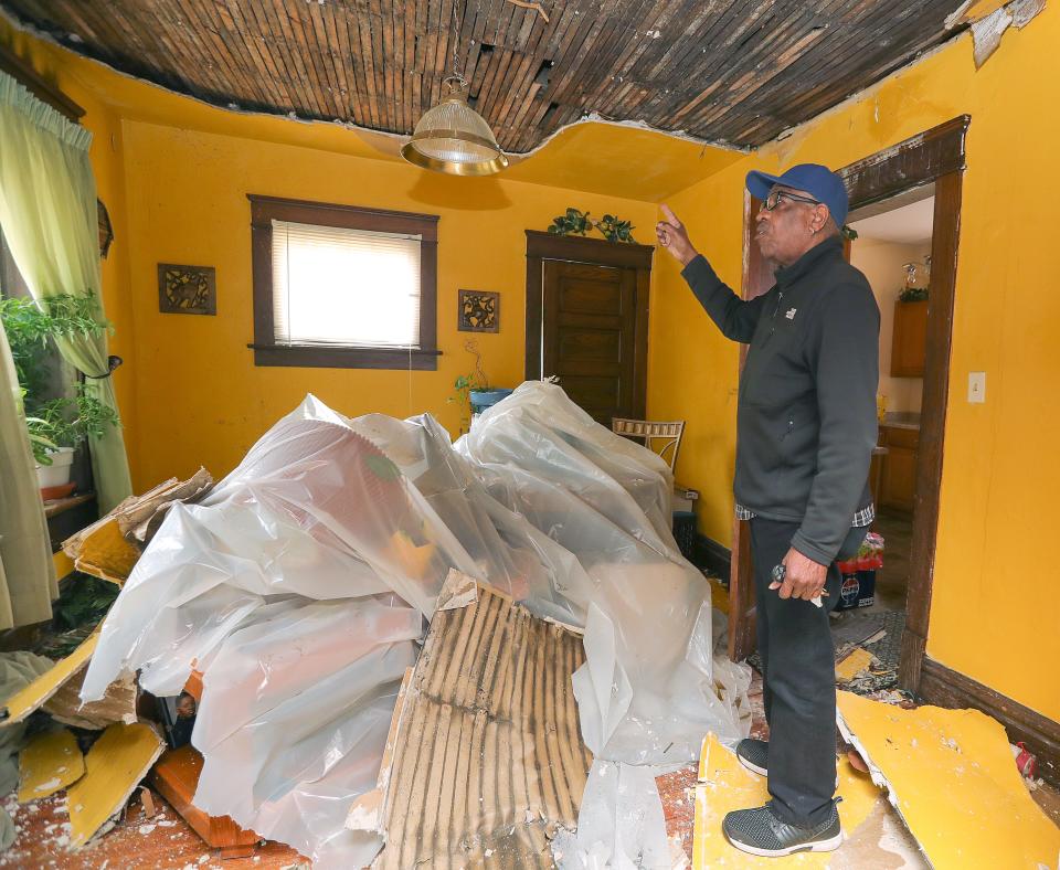 Akron City Councilman Johnnie Hannah surveys fire damage at his East South Street home.