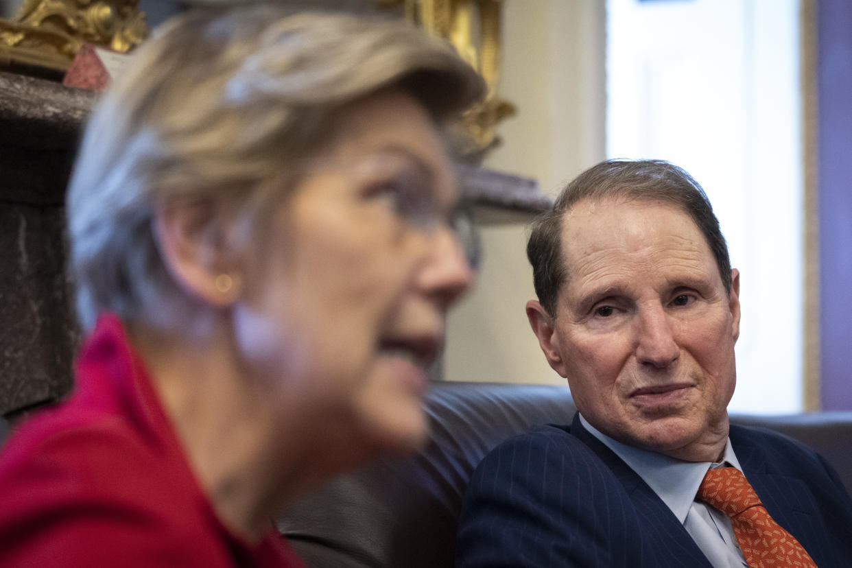 WASHINGTON, DC - OCTOBER 26:  (L-R) U.S. Sens. Elizabeth Warren (D-MA) and Ron Wyden (D-OR) speak to reporters about a corporate minimum tax plan at the U.S. Capitol October 26, 2021 in Washington, DC. The senators detailed a plan that would levy a 15% minimum corporate tax on declared incomes of large corporations and say it could help fund the Biden administration's social policy spending plan that Democrats are currently negotiating. (Photo by Drew Angerer/Getty Images)