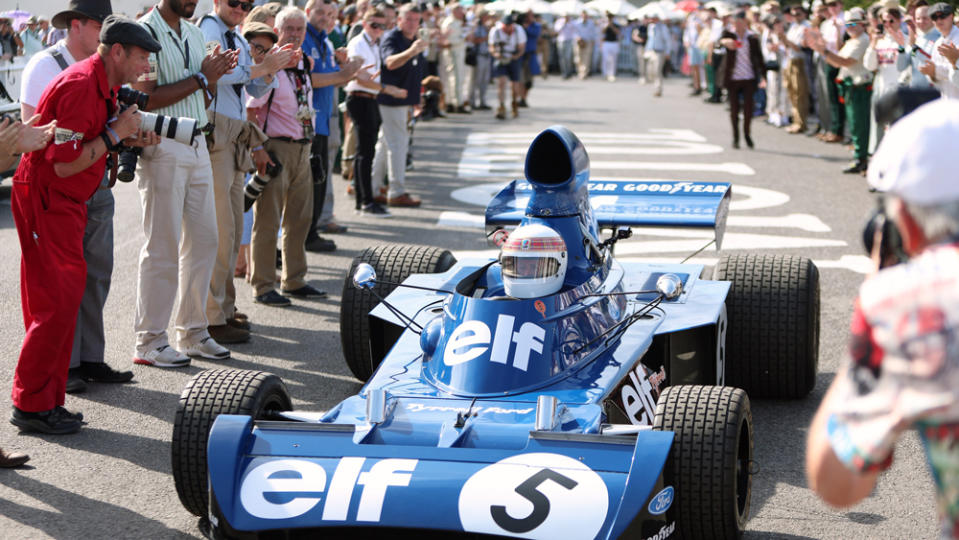 Sir Jackie Stewart makes a grand entrance behind the wheel at the 2023 Goodwood Revival.