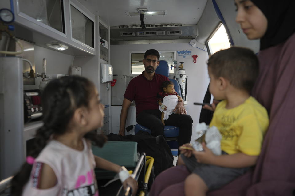 Palestinian children with chronic diseases sit with their relatives before they leave the Gaza Strip for treatment abroad through the Kerem Shalom crossing, in Khan Younis, southern Gaza Strip, Thursday, June 27, 2024. 21 patients in the Gaza Strip evacuated the war-torn enclave in an initiative led by the World Health Organization for the children to receive life-saving treatment elsewhere. (AP Photo/Abdel Kareem Hana)