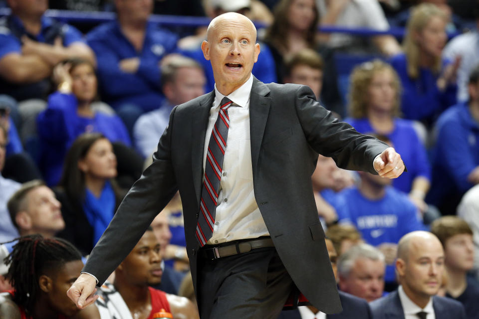Louisville head coach Chris Mack directs his team during the second half of an NCAA college basketball game against Kentucky in Lexington, Ky., Saturday, Dec. 28, 2019. (AP Photo/James Crisp)