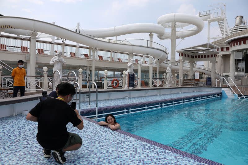 An internet show host poses in the swimming pool on the Explorer Dream cruise ship in Keelung