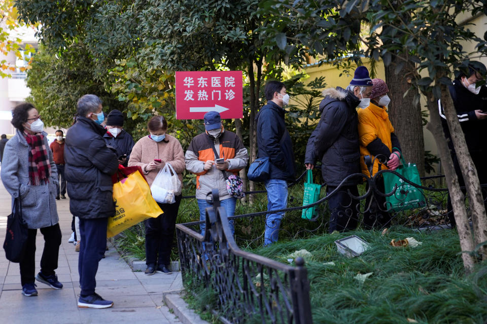 People wearing protective masks line up outside a fever clinic of a hospital, as coronavirus disease (COVID-19) outbreaks continue in Shanghai, China, December 20, 2022. REUTERS/Aly Song