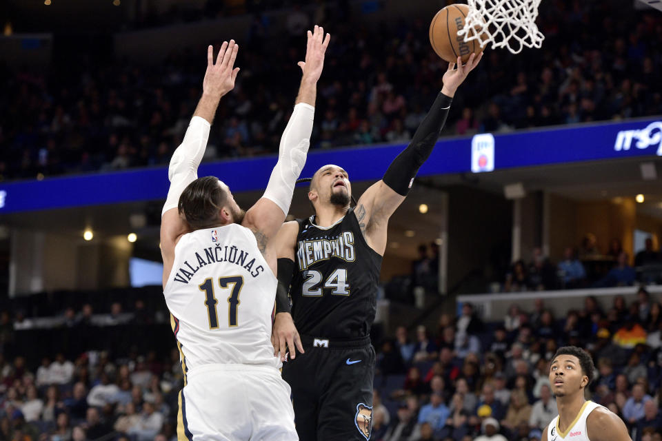 Memphis Grizzlies forward Dillon Brooks (24) shoots against New Orleans Pelicans center Jonas Valanciunas (17) in the second half of an NBA basketball game Friday, Nov. 25, 2022, in Memphis, Tenn. (AP Photo/Brandon Dill)