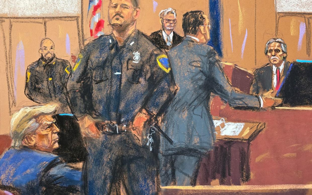 David Pecker, right, is questioned in court on Friday while Donald Trump, left, watches on