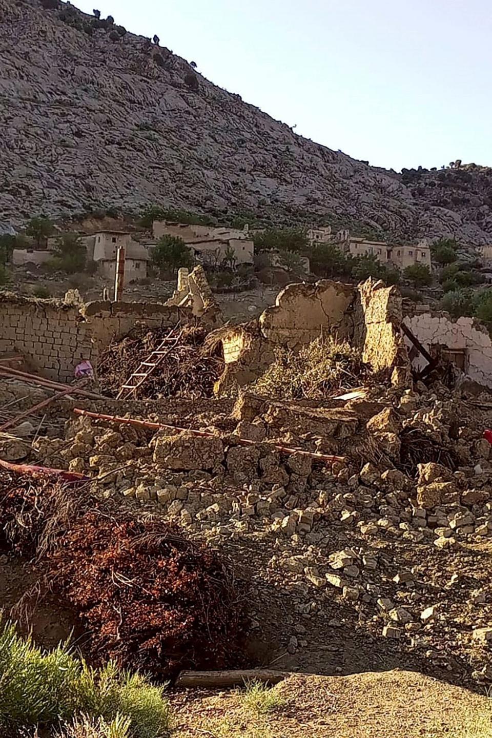 This photograph taken on June 22, 2022 and received as a courtesy of the Afghan government-run Bakhtar News Agency shows collapsed mud houses following an earthquake in Gayan district, Paktika province