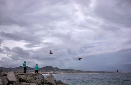 People look on at La Empacadora beach in Cabo San Lucas as Hurricane Lorena churns close to the southern tip of Mexico's Baja California peninsula