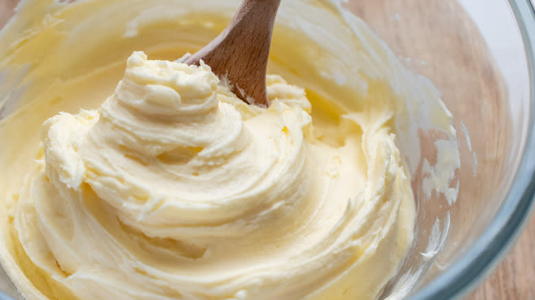 buttercream frosting with wooden spoon