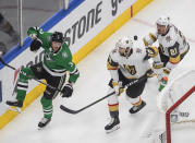 Dallas Stars' John Klingberg (3) and Vegas Golden Knights' Nicolas Roy (10) and Nick Cousins (21) battle for the puck during the second period of Game 4 of the NHL hockey Western Conference final, Saturday, Sept. 12, 2020, in Edmonton, Alberta. (Jason Franson/The Canadian Press via AP)