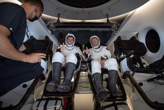 Robert Behnken, left, and spacecraft commander Douglas Hurley, greet recovery crews moments after the hatch of their Crew Dragon capsule was opened. / Credit: NASA/Bill Ingalls