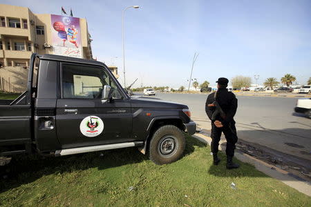 A member of the force assigned to protect Libya's unity government stands on a road leading to where the government has their offices, in Tripoli, Libya March 31, 2016. REUTERS/Ismail Zitouny