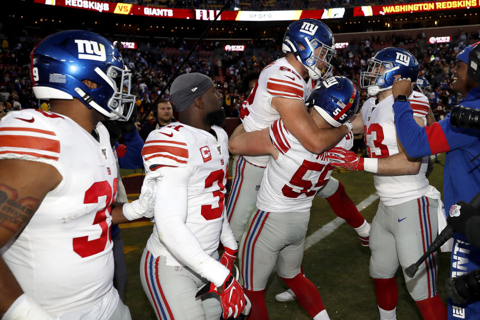 New York Giants outside linebacker David Mayo (55) lifts tight end Kaden Smith, center, after he caught the game-winning touchdown pass from quarterback Daniel Jones during overtime of an NFL football game against the Washington Redskins, Sunday, Dec. 22, 2019, in Landover, Md. The Giants won 41-35 in overtime. (AP Photo/Alex Brandon)