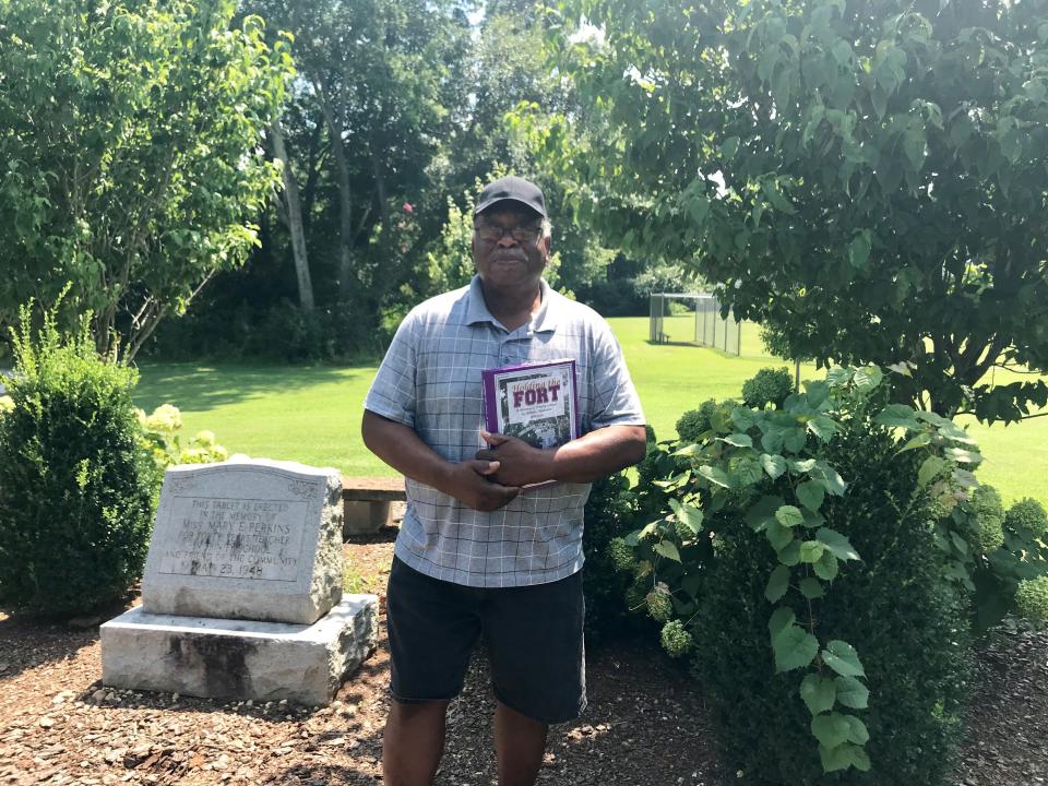 David Malone, a supporter of reparations whose ancestors were slaves in northern Alabama, stands at a memorial at the only black school in Limestone County for decades after the Civil War, which he is helping to preserve.