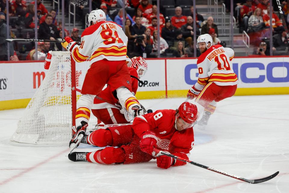 Red Wings defenseman Ben Chiarot trips Flames center Nazem Kadri in front of goaltender Ville Husso in the third period of the Wings' 2-1 win on Thursday, Feb. 9, 2023, at Little Caesars Arena.