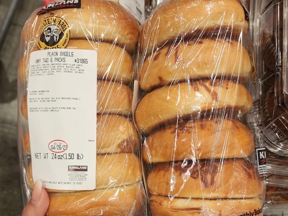 The writer holds a 12-count package of Kirkland Signature bagels