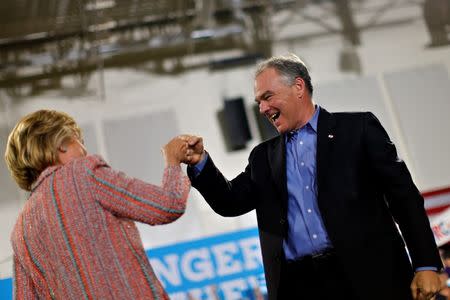 Democratic U.S. presidential candidate Hillary Clinton and U.S. Senator Tim Kaine (D-VA) react during a campaign rally at Ernst Community Cultural Center in Annandale, Virginia, U.S., July 14, 2016. REUTERS/Carlos Barria