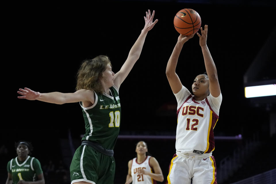 Southern California guard JuJu Watkins (12) shoots against Le Moyne guard Sydney Lusher (10) during the second half of an NCAA college basketball game in Los Angeles, Monday, Nov. 13, 2023. (AP Photo/Ashley Landis)
