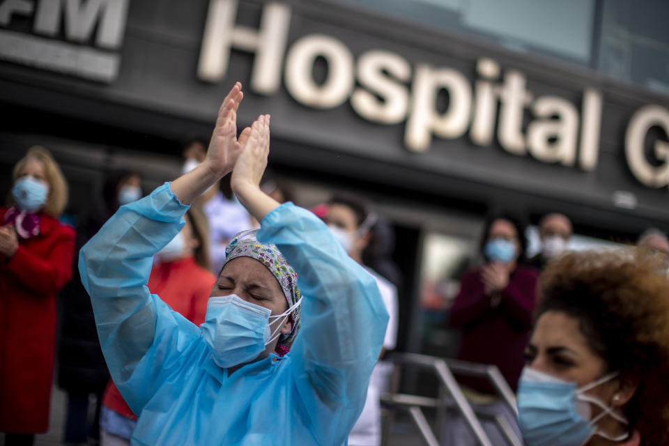 Healthcare workers protest against plans by Madrid's authorities to force staff to transfer to other hospitals at La Paz hospital in Madrid, Spain, Friday, Jan. 22, 2021. Virus infections have been increasing steeply following Christmas and New Year, putting pressure on Spain's public health system. (AP Photo/Manu Fernandez)