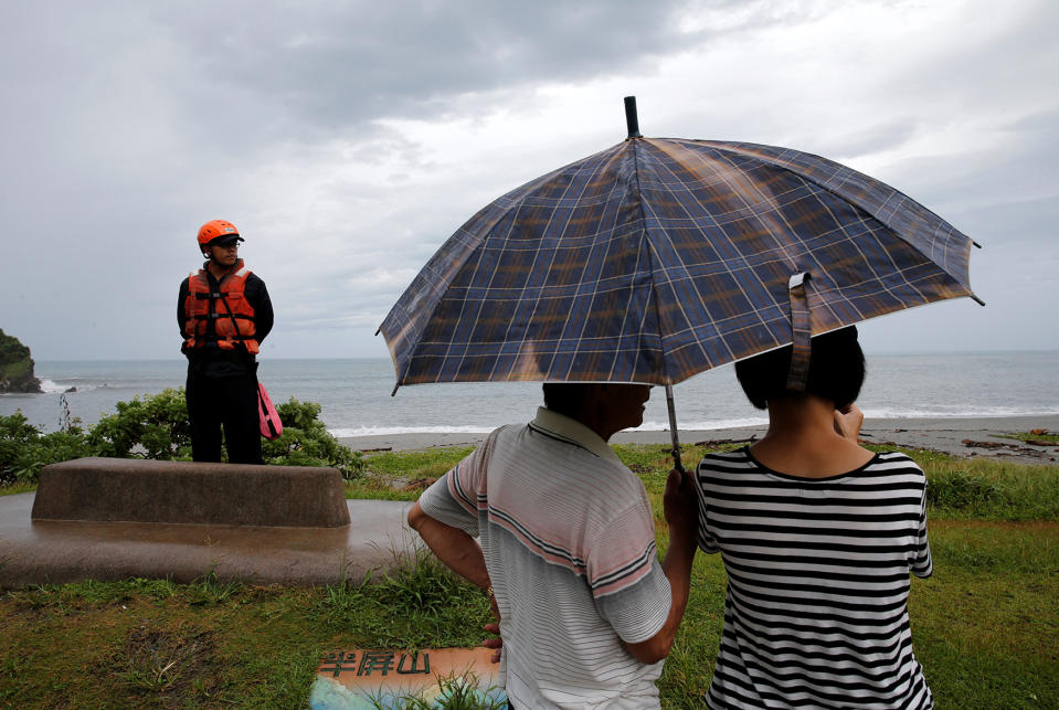 A coast guard stands guard at the coast as Typhoon Malakas approaches in Yilan