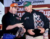 FILE - In this Wednesday, Oct. 6, 1999 file photo, Bobby Labonte, left, of Corpus Christi, Texas celebrates in victory lane with team owner Joe Gibbs after winning the pole position for Sunday's UAW-GM 500 race at the Lowe's Motor Speedway in Concord, N.C. Tony Stewart headlines a Joe Gibbs racing trio that has been elected to the NASCAR Hall of Fame. The three-time Cup Series champion will be inducted alongside car owner Joe Gibbs and former teammate Bobby Labonte. (AP Photo/Chuck Burton, File)