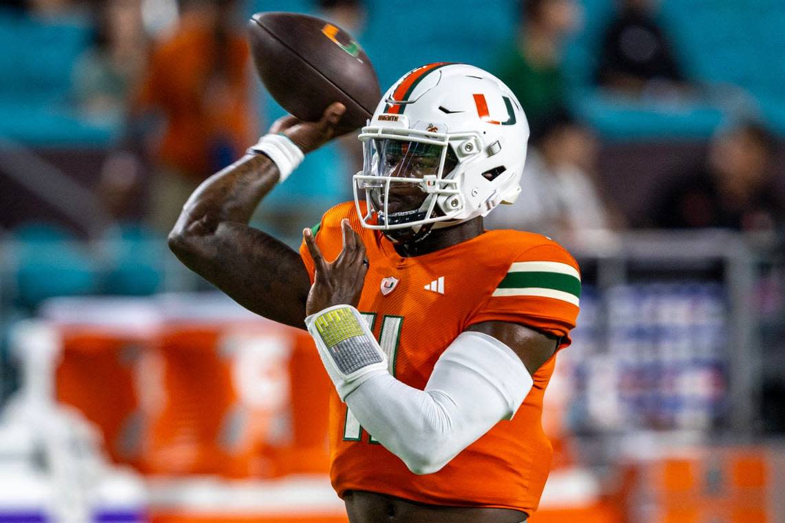 Miami Hurricanes quarterback Jacurri Brown (11) throws the ball before the first quarter of an ACC college football game against Clemson University at Hard Rock Stadium in Miami Gardens, Florida, on Saturday, October 21, 2023.