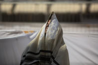 An ultra-Orthodox Jewish man prays ahead of the Jewish new year at the Western Wall, the holiest site where Jews can pray in Jerusalem's old city, Wednesday, Sept. 16, 2020. A raging coronavirus outbreak is casting a shadow over the normally festive Jewish New Year. With health officials recommending a nationwide lockdown, traditional family gatherings will be muted, synagogue prayers will be limited to small groups and roads will be empty.(AP Photo/Sebastian Scheiner)