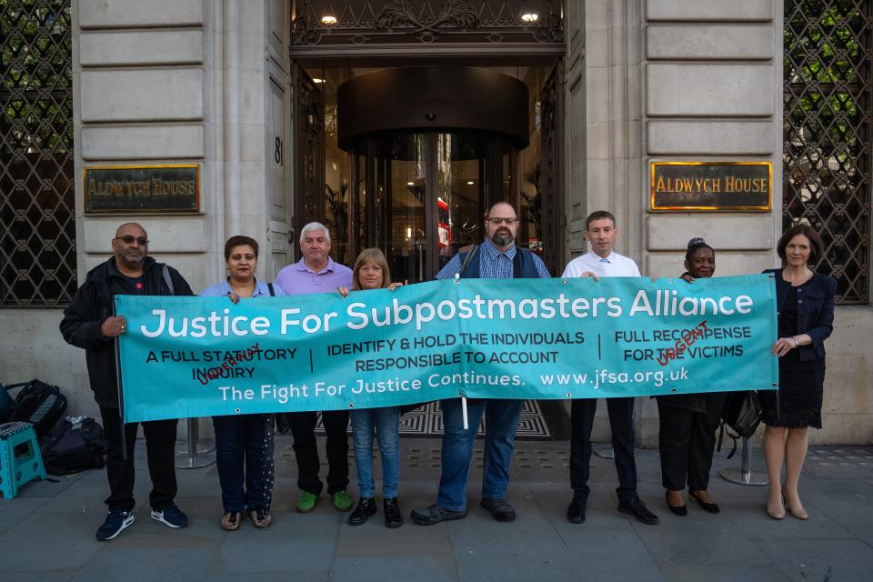 Members of the Justice For Subpostmasters Alliance hold a banner after former Post Office chief executive Paula Vennells arrived (Carl Court/Getty Images)