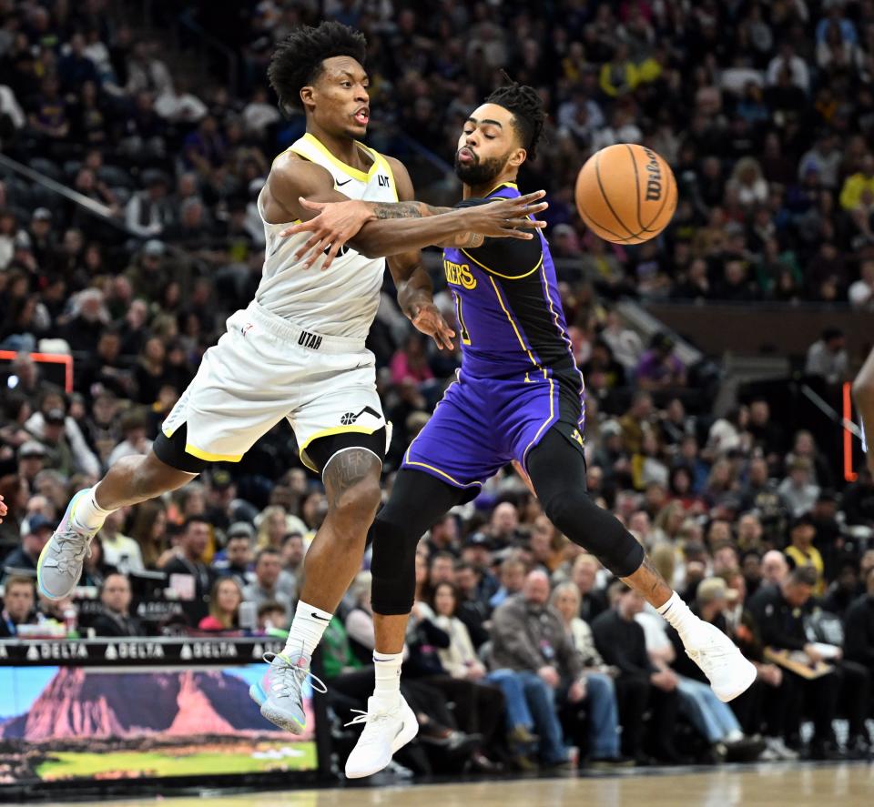 Utah Jazz guard Collin Sexton (2) passes around Los Angeles Lakers guard D’Angelo Russell (1) as Utah and Los Angeles play at the Delta Center in Salt Lake City on Saturday, Jan. 13, 2024. | Scott G Winterton, Deseret News