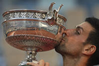 Serbia's Novak Djokovic kisses the cup after defeating Stefanos Tsitsipas of Greece during their final match of the French Open tennis tournament at the Roland Garros stadium Sunday, June 13, 2021 in Paris. Djokovic won 6-7 (6), 2-6, 6-3, 6-2, 6-4. (AP Photo/Michel Euler)