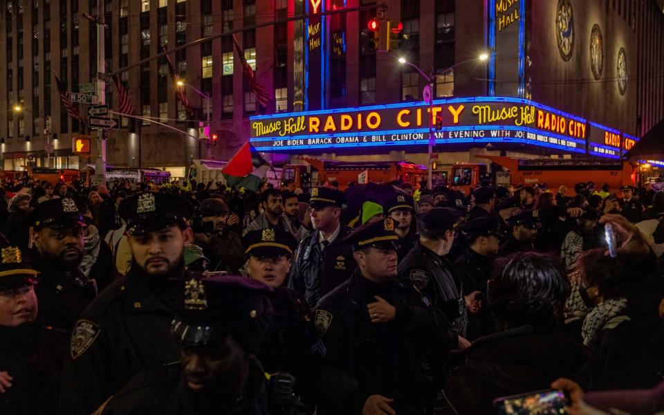 NYPD officers block Pro-Palestinian demonstrators outside Radio City Music Hall during President Joe Biden's fundraiser on March 28, 2024 in New York City. Biden was joined by former presidents Bill Clinton and Barack Obama at the fundraiser