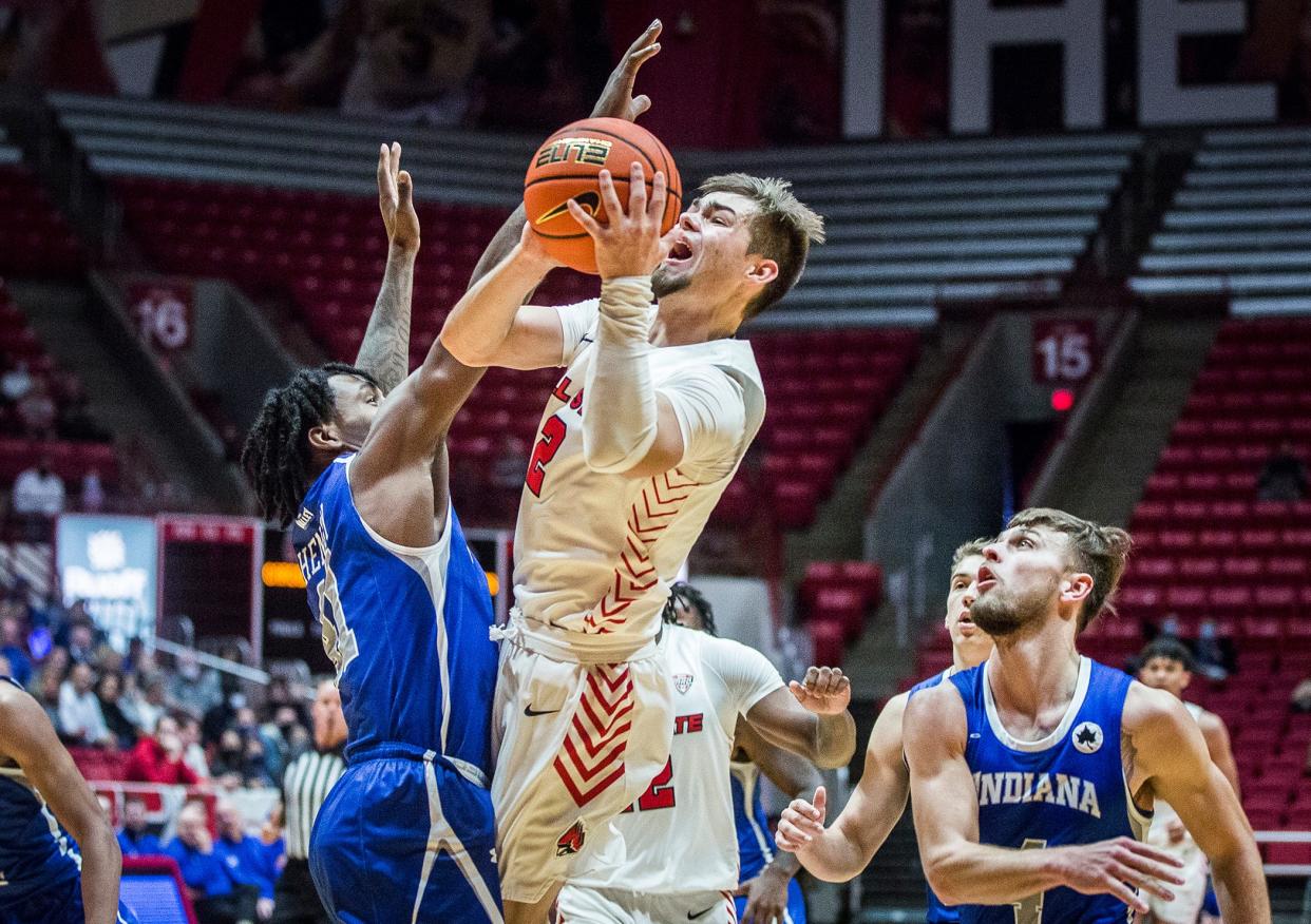 FILE -- Ball State's Luke Bumbalough shoots past Indiana State's defense during their game at Worthen Arena Saturday, Nov. 27, 2021.