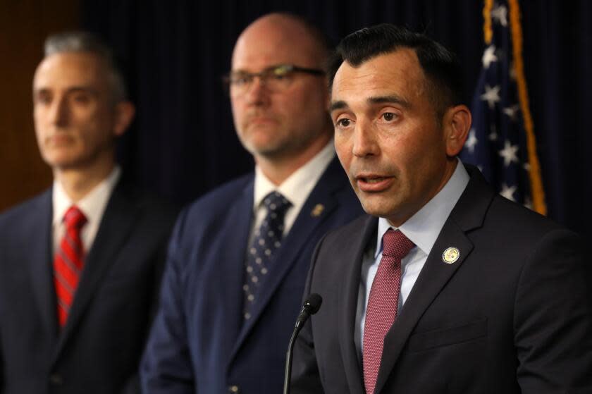 LOS ANGELES, CA - APRIL 11, 2024 - United States Attorney E. Martin Estrada, right, next to IRS Criminal Investigation Special Agent in Charge Tyler Hatcher, center, announces criminal charges against Ippei Mizuhara, who formerly worked as an interpreter for Dodgers star Shohei Ohtani, with stealing more than $16 million from the Ohtani at United States Courthouse in downtown Los Angeles on April 11, 2024. U.S. Attorney Estrada said that Ohtani was a victim in this case. (Genaro Molina/Los Angeles Times)