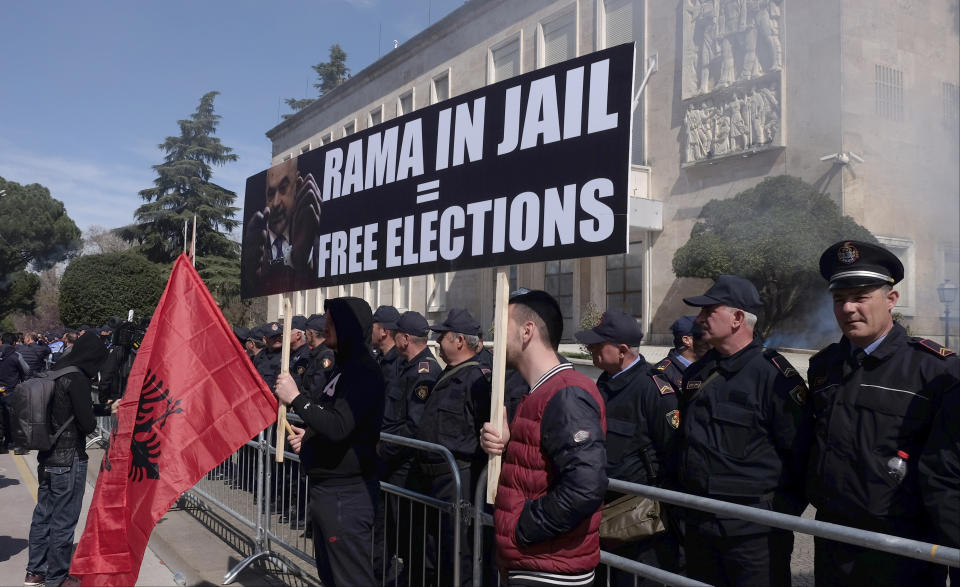 Protesters take part in an anti-government rally in Tirana, Albania, Saturday, March 16, 2019. Thousands of supporters of the center-right Democratic Party-led opposition have gathered on Saturday in front of Socialist Party's Prime Minister Edi Rama to demand his resignation, a transitory Cabinet without him that will prepare fresh elections. (AP Photo/Hektor Pustina)