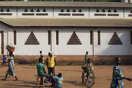 People displaced by fighting walk in front of Saint Antoine de Padoue cathedral in Bossangoa, Central African Republic November 25, 2013. REUTERS/Joe Penney